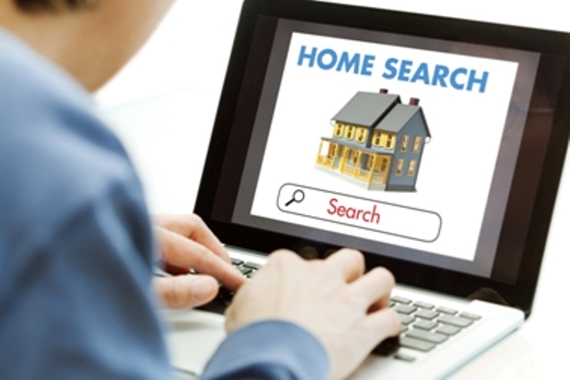 man searching for homes for sale online