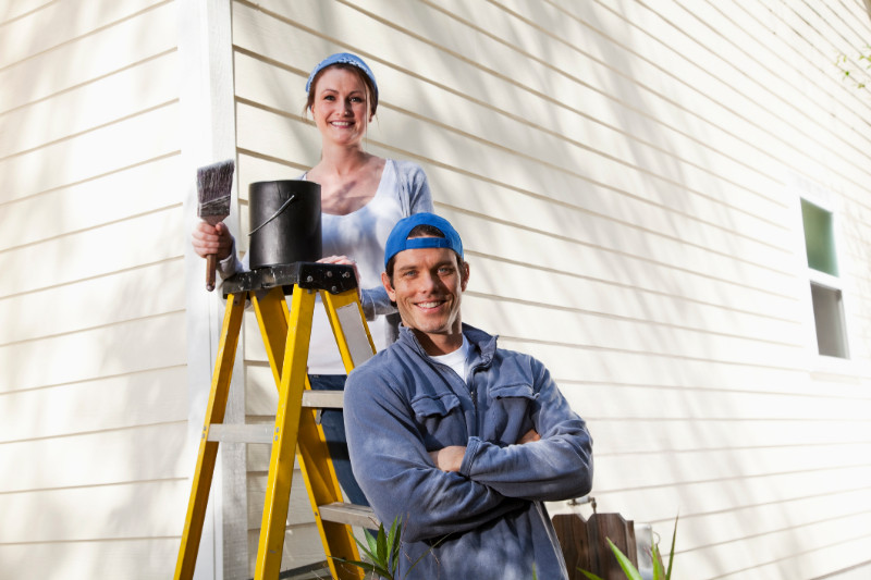 A couple painting their house