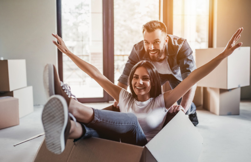 A happy couple playing with a box