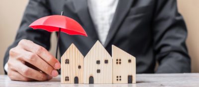 a man in suits holding an umbrella for a house miniture