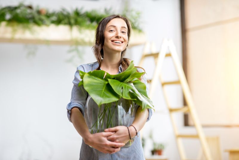 woman with plant at home