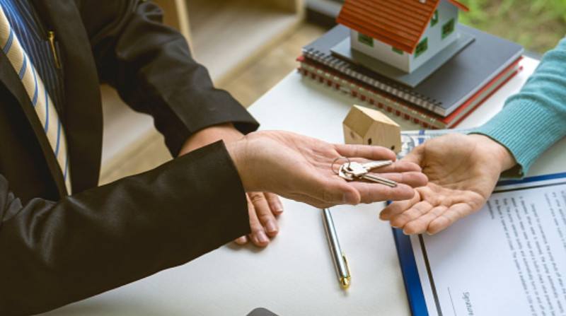 A sales agent offering a home purchase to a client